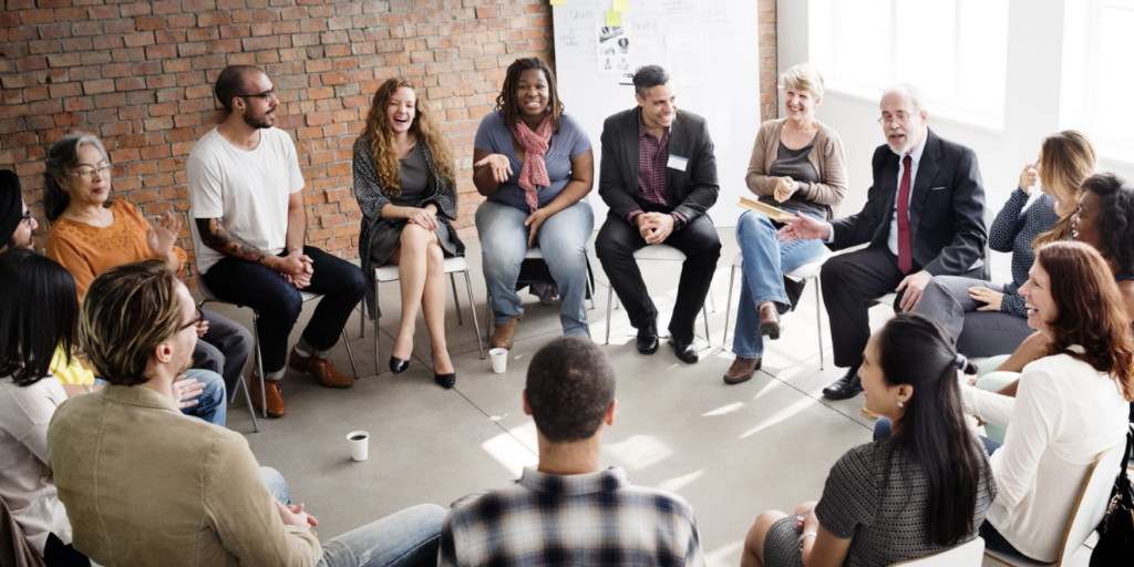 A group of adults sitting on chairs in a circle