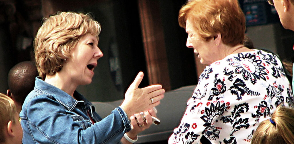 Image shows two women in animated discussion with one another